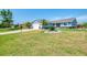 Beautiful single-story home with a manicured lawn and landscaping, plus a two-car garage at 5872 Monroe Rd, Venice, FL 34293