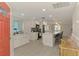 Open concept kitchen featuring white cabinets, stainless appliances, and a large island at 5872 Monroe Rd, Venice, FL 34293