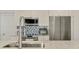 Close-up of modern kitchen appliances including a stainless steel refrigerator, microwave, and stovetop with designer backsplash at 5872 Monroe Rd, Venice, FL 34293