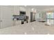 Kitchen featuring white cabinets, tiled backsplash, stainless appliances and granite counters at 5872 Monroe Rd, Venice, FL 34293