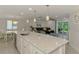Open concept kitchen with island, seating, and view to living and dining areas at 5872 Monroe Rd, Venice, FL 34293