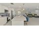 Spacious kitchen with long island with white cabinets and modern stainless steel appliances at 5872 Monroe Rd, Venice, FL 34293
