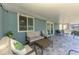Cozy screened lanai with outdoor seating and decor, providing an ideal space for relaxation and entertaining at 5872 Monroe Rd, Venice, FL 34293