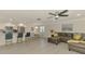 Open concept floor plan connecting kitchen, living room, and dining area with consistent tile flooring at 5872 Monroe Rd, Venice, FL 34293