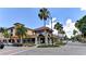 Charming neighborhood commercial building with patio seating under palm trees and a blue sky at 5872 Monroe Rd, Venice, FL 34293