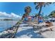 Waterfront dining with picnic tables and colorful umbrellas, offering stunning views of the water at 5872 Monroe Rd, Venice, FL 34293