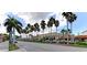 Charming street view with palm trees lining the street and a variety of shops and restaurants at 5872 Monroe Rd, Venice, FL 34293