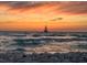 Beautiful sunset view on the beach with a sailboat sailing into the sunset sky and gentle waves at 5872 Monroe Rd, Venice, FL 34293