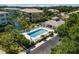 Aerial view of the pool and clubhouse, set amongst lovely landscaping and waterways at 600 Gardens Edge Dr # 613, Venice, FL 34285