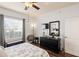 Bright bedroom with hardwood floors, a ceiling fan, and an elegant black dresser at 600 Gardens Edge Dr # 613, Venice, FL 34285