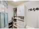 Well-organized closet with built in shelving and drawers and soft blue window treatments at 600 Gardens Edge Dr # 613, Venice, FL 34285