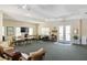 Resident clubhouse featuring tables, lounge area, and entertainment at 600 Gardens Edge Dr # 613, Venice, FL 34285