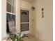 Inviting front entrance with door, Welcome Home sign, a house number of 613, and decorative plant at 600 Gardens Edge Dr # 613, Venice, FL 34285