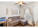 Cozy living room with hardwood floors, a grey sectional couch, and natural light at 600 Gardens Edge Dr # 613, Venice, FL 34285