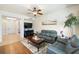 Bright and open living space with hardwood floors, decorative shelves, large TV, and an inviting atmosphere at 600 Gardens Edge Dr # 613, Venice, FL 34285