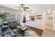 Open-concept living room adjacent to the kitchen area, with hardwood floors, contemporary furnishings, and lanai access at 600 Gardens Edge Dr # 613, Venice, FL 34285