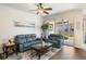 Comfortable living room featuring hardwood floors, sliding glass doors to a lanai, and contemporary furnishings at 600 Gardens Edge Dr # 613, Venice, FL 34285