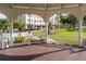 Inviting view from a gazebo in Venice, Florida, overlooking a green park and picturesque street at 600 Gardens Edge Dr # 613, Venice, FL 34285