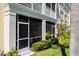 Screened in patio with lush greenery under a bright white overhang with views of the yard at 600 Gardens Edge Dr # 613, Venice, FL 34285
