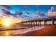 Scenic view of a wooden pier stretching into the ocean at sunset with colorful skies at 600 Gardens Edge Dr # 613, Venice, FL 34285