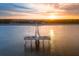 Aerial view of a pier extending into the ocean, with people enjoying the views at sunset at 600 Gardens Edge Dr # 613, Venice, FL 34285
