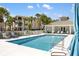 Community pool with lounge chairs and a view of the clubhouse at 600 Gardens Edge Dr # 613, Venice, FL 34285