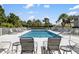 Community pool area with lots of lounge seating and beautiful landscaping at 600 Gardens Edge Dr # 613, Venice, FL 34285