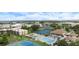 This aerial view highlights a pool, clubhouse, and manicured landscaping in this community at 612 Bird Bay S Dr # 308, Venice, FL 34285