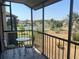 Relaxing screened balcony offering views of the complex's tennis courts and surrounding greenery at 612 Bird Bay S Dr # 308, Venice, FL 34285