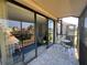Screened balcony with seating offers views into the well manicured community at 612 Bird Bay S Dr # 308, Venice, FL 34285