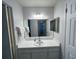 This bathroom has a large mirror, neutral paint, and sufficient storage at 612 Bird Bay S Dr # 308, Venice, FL 34285