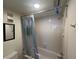 A shower/tub area with white tiles and an overhead light fixture is the focus of this bathroom at 612 Bird Bay S Dr # 308, Venice, FL 34285