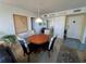 Cozy dining area with a wooden table, floral chairs, and neutral walls at 612 Bird Bay S Dr # 308, Venice, FL 34285