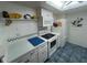 Efficient kitchen featuring white appliances, ample counter space, and skylight at 612 Bird Bay S Dr # 308, Venice, FL 34285