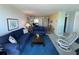 Inviting living room with blue sofas, a rocking chair, and access to the dining area at 612 Bird Bay S Dr # 308, Venice, FL 34285
