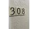 Close-up of the unit number 308 displayed on the exterior wall at 612 Bird Bay S Dr # 308, Venice, FL 34285