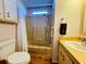 Cozy bathroom featuring a shower-tub combo and a standard toilet at 615 S Green Cir, Venice, FL 34285