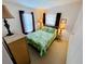 Cozy bedroom with leaf-patterned bedspread and natural lighting at 615 S Green Cir, Venice, FL 34285
