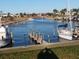 Scenic boat docks with various boats moored along a calm canal surrounded by lush greenery and residences at 615 S Green Cir, Venice, FL 34285