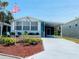 Charming single-story home with well-manicured lawn, covered parking, and cozy patio at 615 S Green Cir, Venice, FL 34285