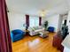 Bright living room features hardwood floors and comfortable seating at 615 S Green Cir, Venice, FL 34285
