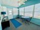 Enclosed porch features neutral carpet, blue accents, and natural light at 615 S Green Cir, Venice, FL 34285