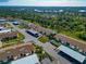 Aerial view of condo community surrounded by lush landscaping, woods, and a pond; close to area beaches at 6796 Gasparilla Pines Blvd # 18, Englewood, FL 34224