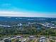 Distant aerial view of home and community, with landscaping and ponds at 6796 Gasparilla Pines Blvd # 18, Englewood, FL 34224