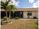 Backyard of home featuring an enclosed patio area and tropical landscaping at 6796 Gasparilla Pines Blvd # 18, Englewood, FL 34224