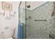 Bathroom showcasing a tiled shower with glass door, toilet and decorative towels at 6796 Gasparilla Pines Blvd # 18, Englewood, FL 34224