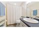 Bathroom featuring a shower with a white curtain, toilet, sink and decor at 6796 Gasparilla Pines Blvd # 18, Englewood, FL 34224