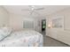 Bright bedroom with beach-themed bedding, ceiling fan, and access to outdoor view at 6796 Gasparilla Pines Blvd # 18, Englewood, FL 34224