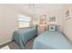 Bedroom featuring twin beds with blue bedding, decor, and a window at 6796 Gasparilla Pines Blvd # 18, Englewood, FL 34224