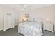 Cozy bedroom with beach-themed decor, white furnishings, and a ceiling fan at 6796 Gasparilla Pines Blvd # 18, Englewood, FL 34224